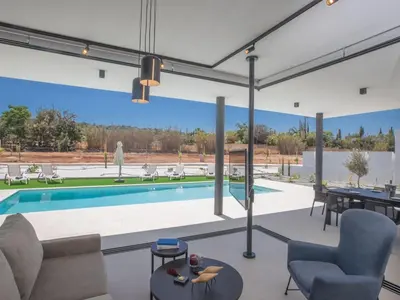 a living room with a swimming pool and a large window at Holiday Home in Protaras mit großem Garten by Interhome in Protaras