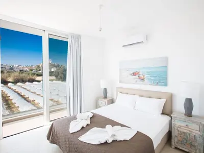 a bedroom with a bed and a large window at Holiday Home 3-Schlafzimmer-Villa mit privatem Pool im Zentrum by Interhome in Protaras