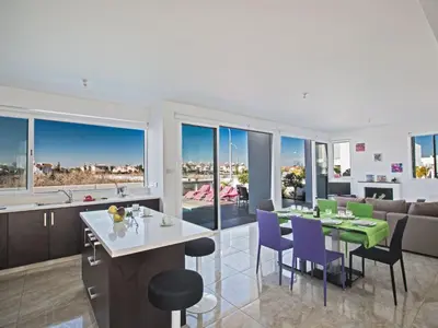 a kitchen and living room with a table and chairs at Holiday Home Protaras Perle Villa PE16 by Interhome in Protaras