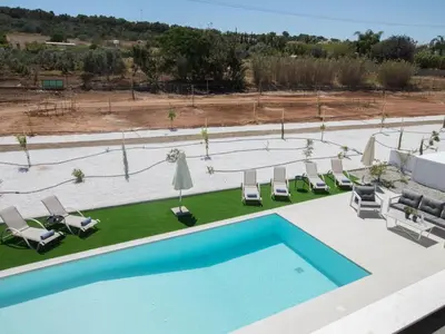 an overhead view of a pool with chairs and umbrellas at Holiday Home mit Privatpool für 11 Personen ca- 220 m² in Protaras- Südküste von Zypern by Interhome in Protaras
