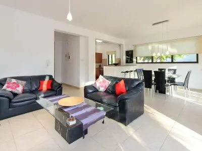 a living room with two black leather couches and a table at Holiday Home Protaras Ferienvilla AV6 by Interhome in Protaras
