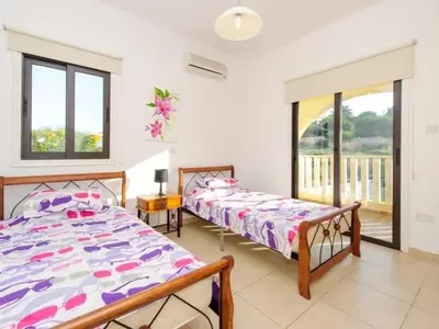 a bedroom with two beds and a balcony at Holiday Home Protaras Ferienvilla AV6 by Interhome in Protaras
