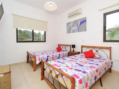 a bedroom with two beds and a window at Holiday Home Protaras Ferienvilla AV6 by Interhome in Protaras