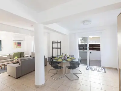 a living room with a table and a couch at Holiday Home Protaras Blauer Fluss Villa BR26 by Interhome in Protaras