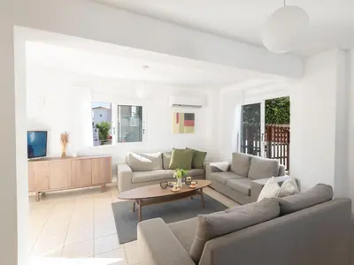 a living room with two couches and a table at Holiday Home Protaras Blauer Fluss Villa BR26 by Interhome in Protaras