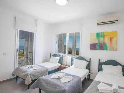a room with two beds and two windows at Holiday Home Ferienvilla Chloe mit Terrasse und Garten by Interhome in Protaras