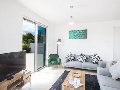 a living room with a couch and a tv at Holiday Home Schöne- topmoderne Ferienvilla auf Zypern by Interhome in Protaras