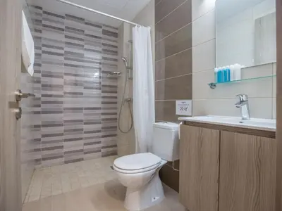 a bathroom with a toilet and a sink and a shower at Holiday Home Schöne- topmoderne Ferienvilla auf Zypern by Interhome in Protaras