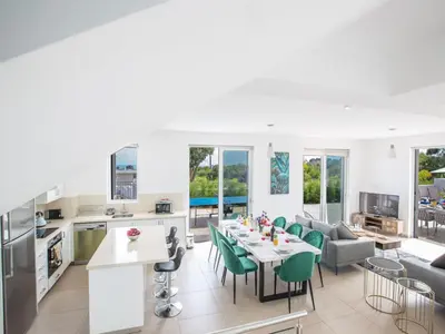 a kitchen and living room with a table and chairs at Holiday Home Schöne- topmoderne Ferienvilla auf Zypern by Interhome in Protaras