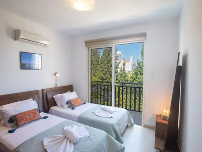 a bedroom with two beds and a balcony at Holiday Home Protaras Menelaos Villa MV7 by Interhome in Paralimni