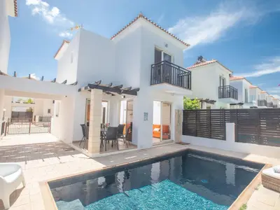 a white house with a swimming pool in front of it at Holiday Home Protaras Menelaos Villa MV7 by Interhome in Paralimni