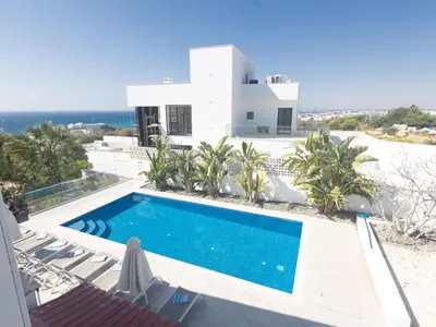 a villa with a swimming pool in front of a house at Holiday Home Ferienvilla Mo 3 für 10 Personen in Agia Napa by Interhome in Ayia Napa