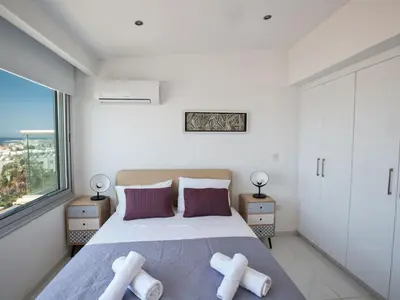 a bedroom with a large bed and a large window at Apartment Schöne Wohnung in Ayia Napa mit Garten by Interhome in Ayia Napa