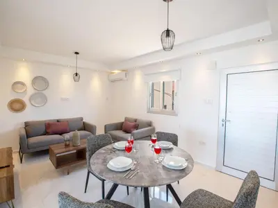 a living room with a table and chairs at Apartment Schöne Wohnung in Ayia Napa mit Garten by Interhome in Ayia Napa