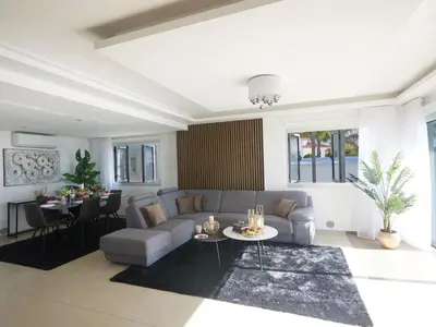 a living room with a couch and a table at Holiday Home Moderne- geräumige Ferienvilla by Interhome in Ayia Napa