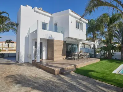 a white house with a patio and a yard at Holiday Home Moderne- geräumige Ferienvilla by Interhome in Ayia Napa