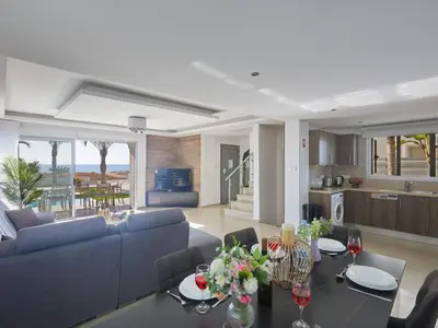 a living room with a couch and a table at Holiday Home Moderne- geräumige Ferienvilla by Interhome in Ayia Napa