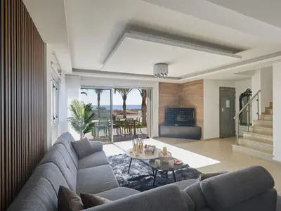 a living room with a couch and a table at Holiday Home Moderne- geräumige Ferienvilla by Interhome in Ayia Napa