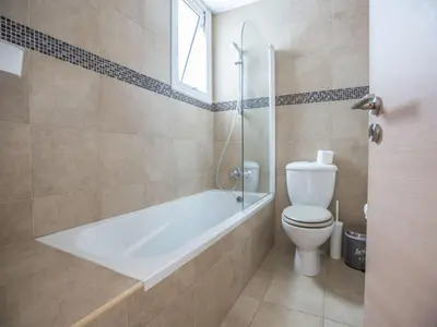 a bathroom with a tub and a toilet and a shower at Holiday Home 3-Schlafzimmer-Villa mit privatem Pool by Interhome in Protaras