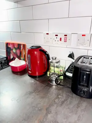 a red toaster sitting on a counter with a toaster at Lapta Red 1 bedroom apartment
