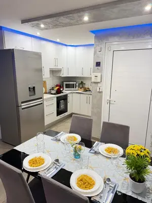 a kitchen with a table with plates of food on it at Lights of Paradise - Your Happy Escape in Ayia Napa