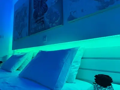 a bed with blue lights on top of it at Lights of Paradise - Your Happy Escape in Ayia Napa