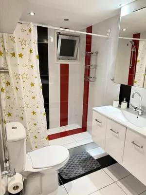 a bathroom with a white toilet and a sink at Lights of Paradise - Your Happy Escape in Ayia Napa