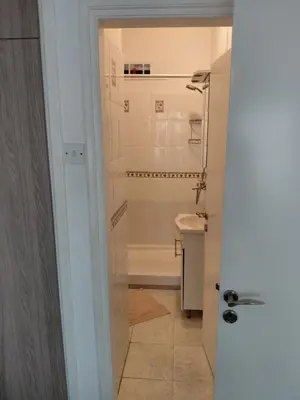 a bathroom with a tub and a toilet and a sink at Queen victoria sea view apartments in Larnaka