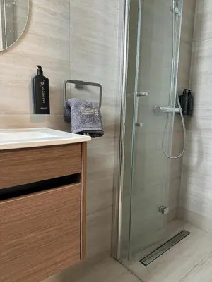a bathroom with a shower and a sink at Nesea Seaside Luxury Escape in Paralimni