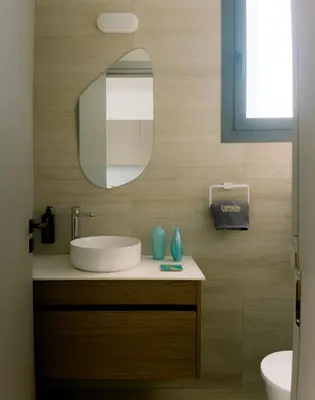 a bathroom with a sink and a mirror at Nesea Seaside Luxury Escape in Paralimni