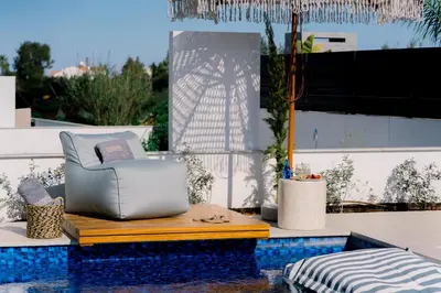a chair sitting on a table next to a pool at Nesea Seaside Luxury Escape in Paralimni