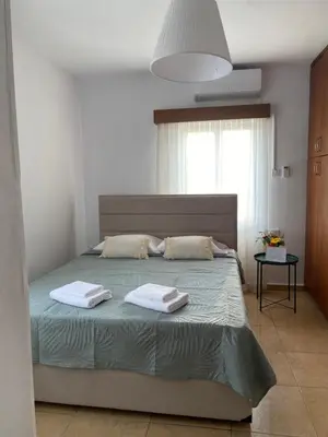 a bedroom with a bed with two towels on it at Barbaras House in Kato Pyrgos
