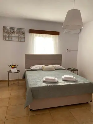 a bedroom with a bed with two towels on it at Barbaras House in Kato Pyrgos