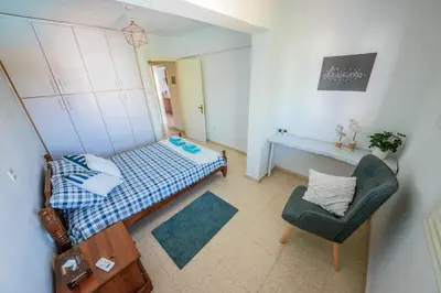 a small bedroom with a bed and a chair at Trinidad, 1 - A in Paralimni