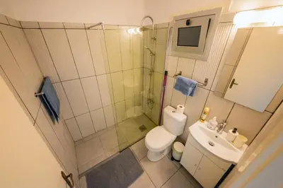 a bathroom with a shower and a toilet and a sink at Trinidad, 1 - A in Paralimni