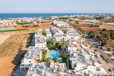 an aerial view of a city with white buildings and the ocean at Trinidad, 1 - A in Paralimni