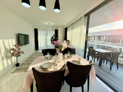a dining room with a table and chairs at Brand new 2 bedrooms apartment in Grand Sapphire in İskele