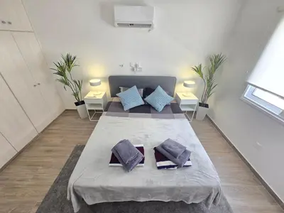 a bedroom with a bed with two pillows on it at 1 bedroom, Agia Napa 1 - C in Ayia Napa