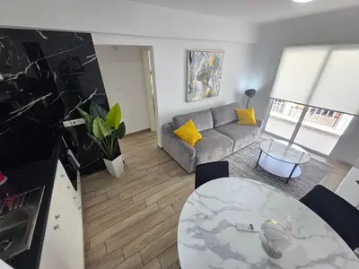 a living room with a couch and a table at 1 bedroom, Agia Napa 1 - C in Ayia Napa