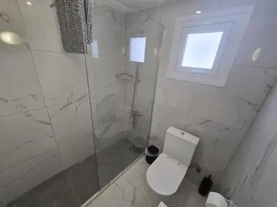a bathroom with a toilet and a glass shower at 1 bedroom, Agia Napa 1 - C in Ayia Napa