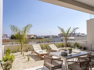 a patio with a table and chairs on a roof at Mythical seas 004 in Paralimni