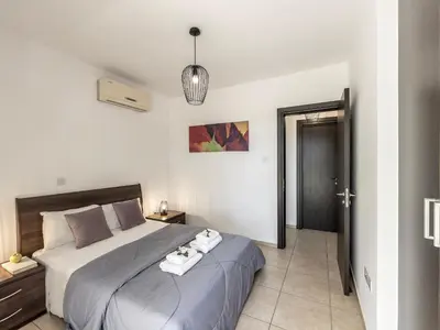 a bedroom with a large bed with towels on it at Mythical Sands CB04 in Paralimni