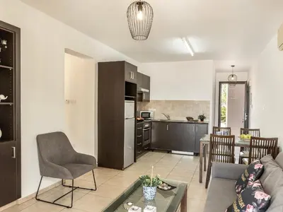 a living room with a couch and a table at Mythical Sands CB04 in Paralimni