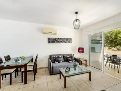 a living room with a couch and a table at Mythical Sands CB04 in Paralimni