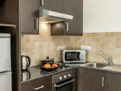 a kitchen with a microwave and a bowl of fruit on the counter at Mythical Sands CB04 in Paralimni