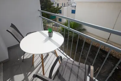 a white table and chairs on a balcony at Napa Apollo 's Nest in Ayia Napa