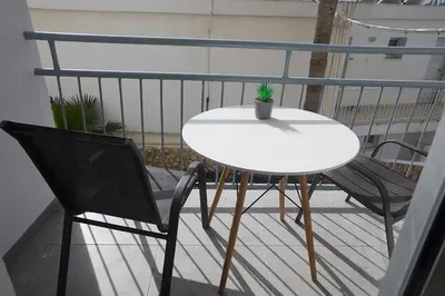 a white table and two chairs on a balcony at Napa Apollo 's Nest in Ayia Napa