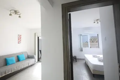 a living room with a couch and a mirror at Napa Apollo 's Nest in Ayia Napa