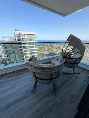a balcony with a hammock and a view of a city at Super Luxury 1 bedroom apartment on 27th floor in Grand Sapphire in Phrenaros