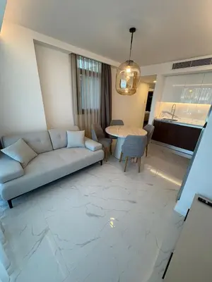 a living room with a couch and a table at Super Luxury 1 bedroom apartment on 27th floor in Grand Sapphire in Phrenaros